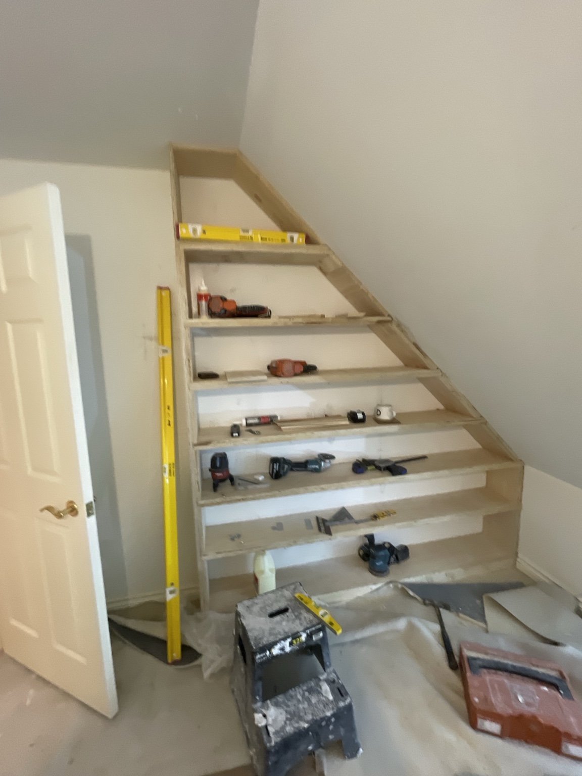 Shelves being built to follow the roofline.