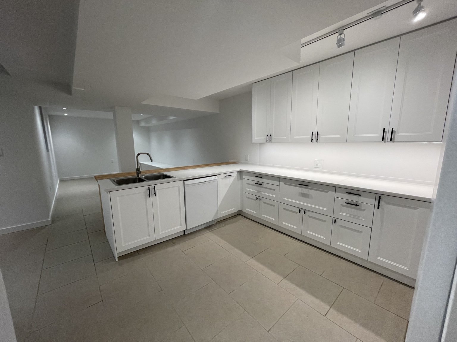 Finished basement rental kitchen using carefully fitted IKEA cabinetry